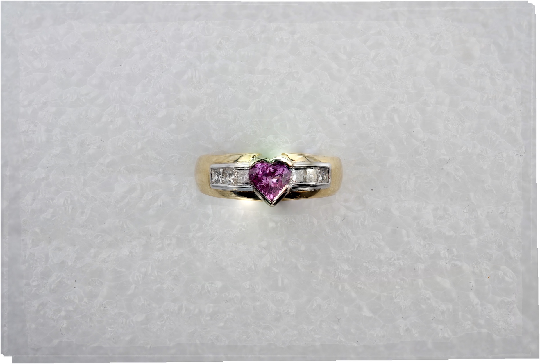 A pink sapphire and diamond ring